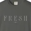 Close-up of the Fresh Serif Caps print on a Pepper Comfort Colors 1717 tee
