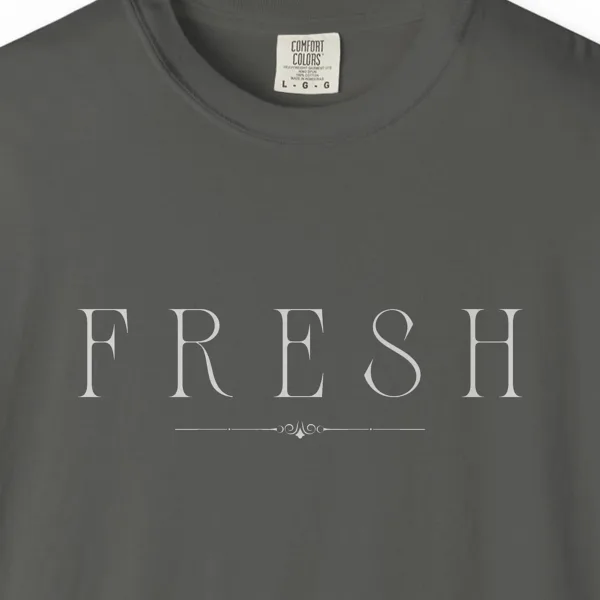 Close-up of the Fresh Serif Caps print on a Pepper Comfort Colors 1717 tee