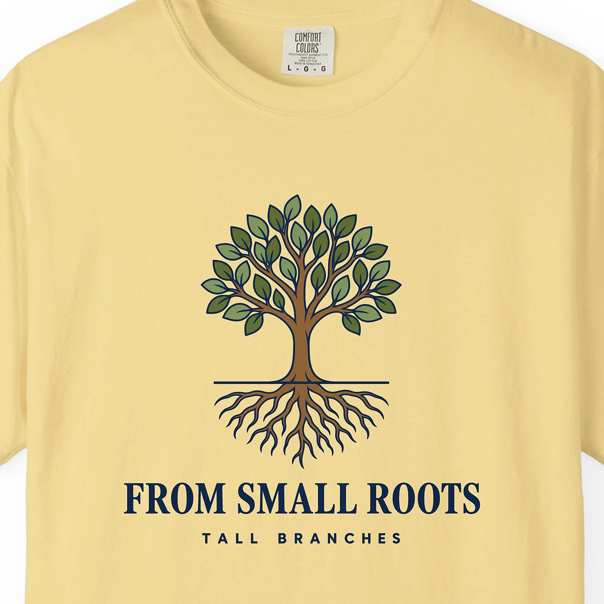 Close-up of the From Small Roots print on a Butter Comfort Colors 1717 tee