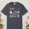 Gathered Seashells design on a Navy Comfort Colors 1717 tee, laid flat