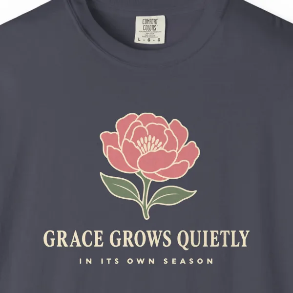 Close-up of the Grace Grows Quietly print on a Navy Comfort Colors 1717 tee