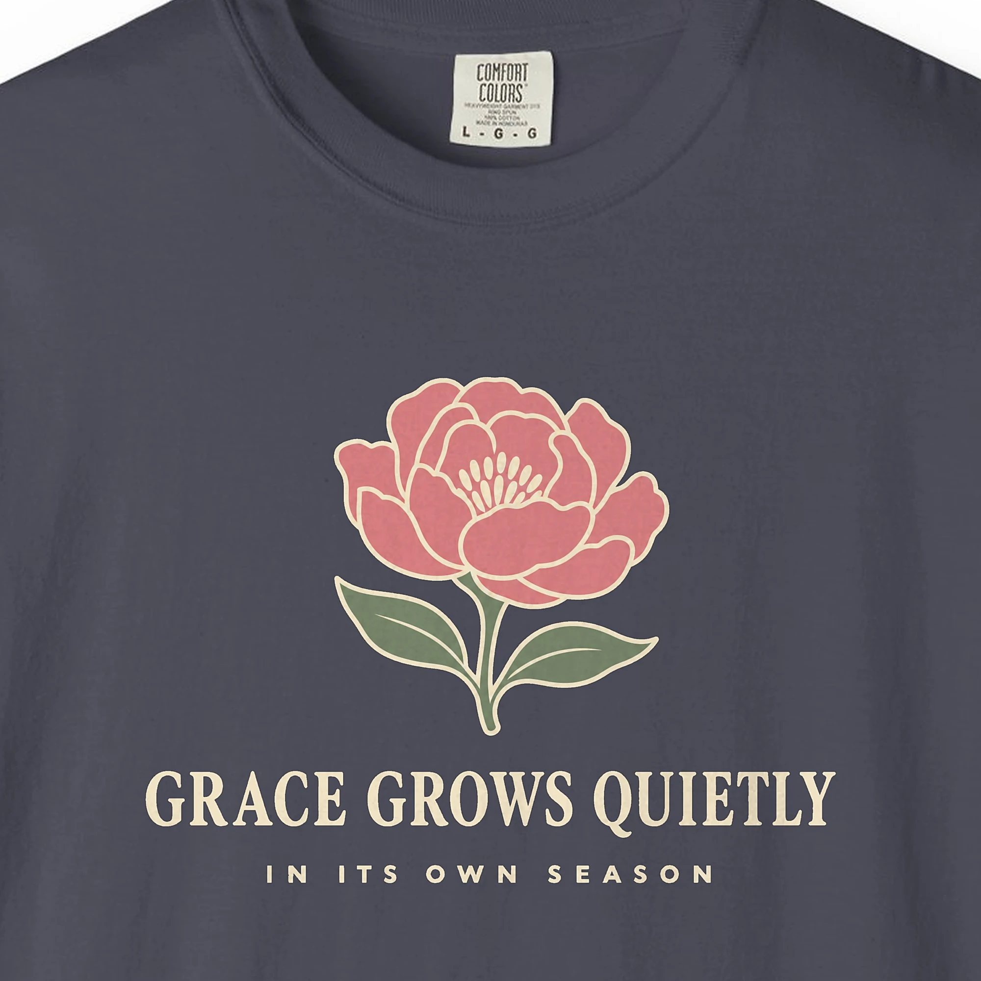 Close-up of the Grace Grows Quietly print on a Navy Comfort Colors 1717 tee