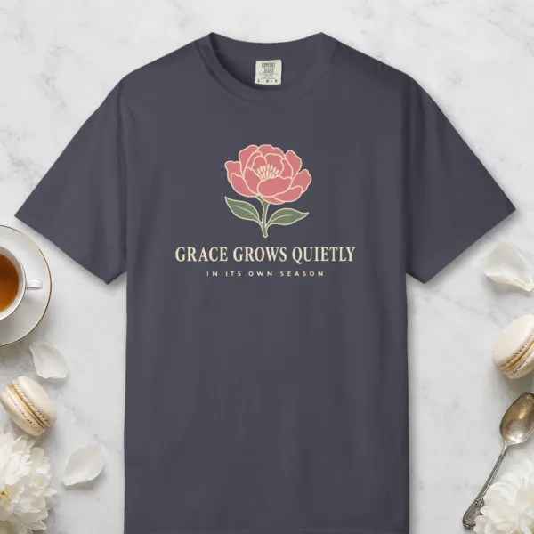 Grace Grows Quietly design on a Navy Comfort Colors 1717 tee, laid flat