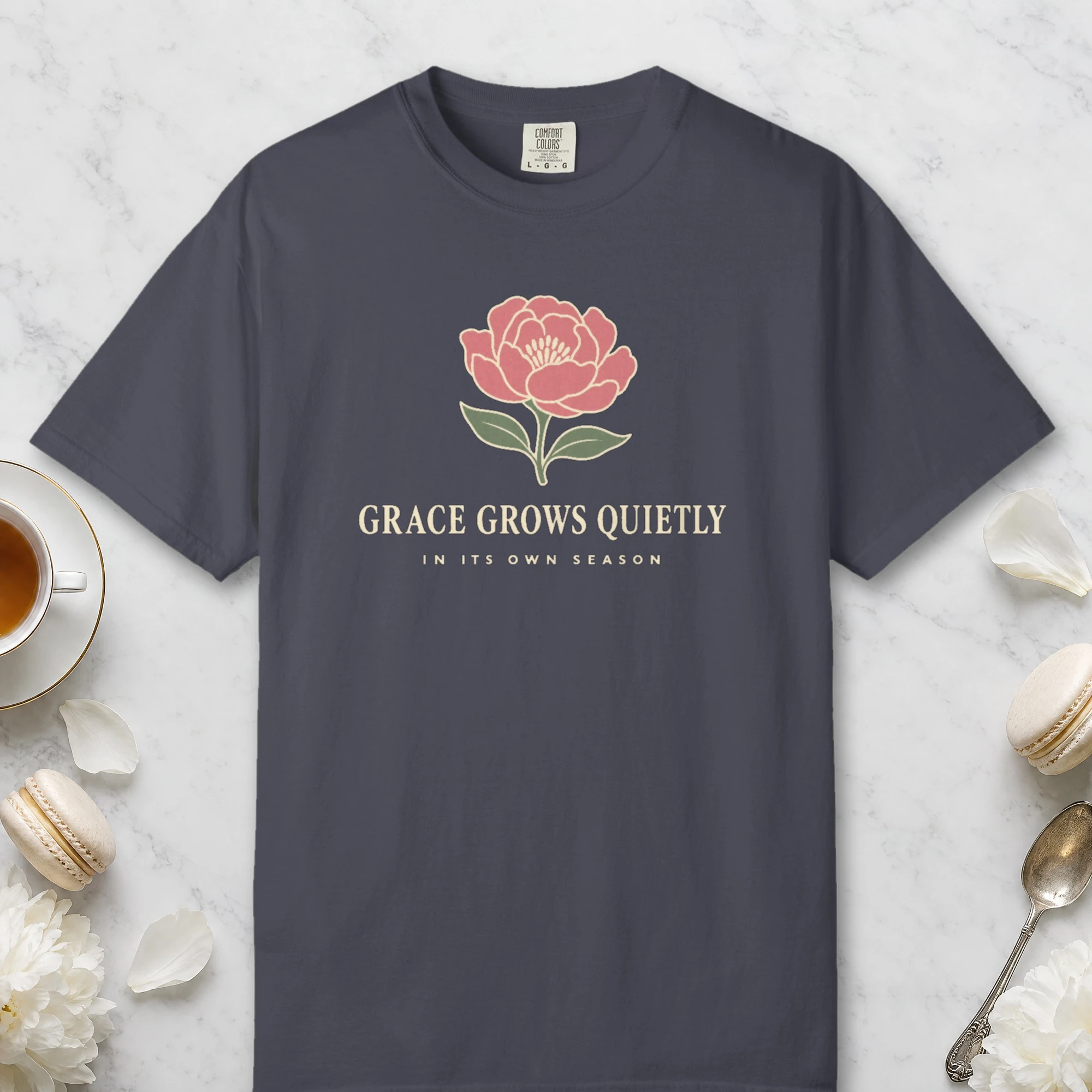 Grace Grows Quietly design on a Navy Comfort Colors 1717 tee, laid flat