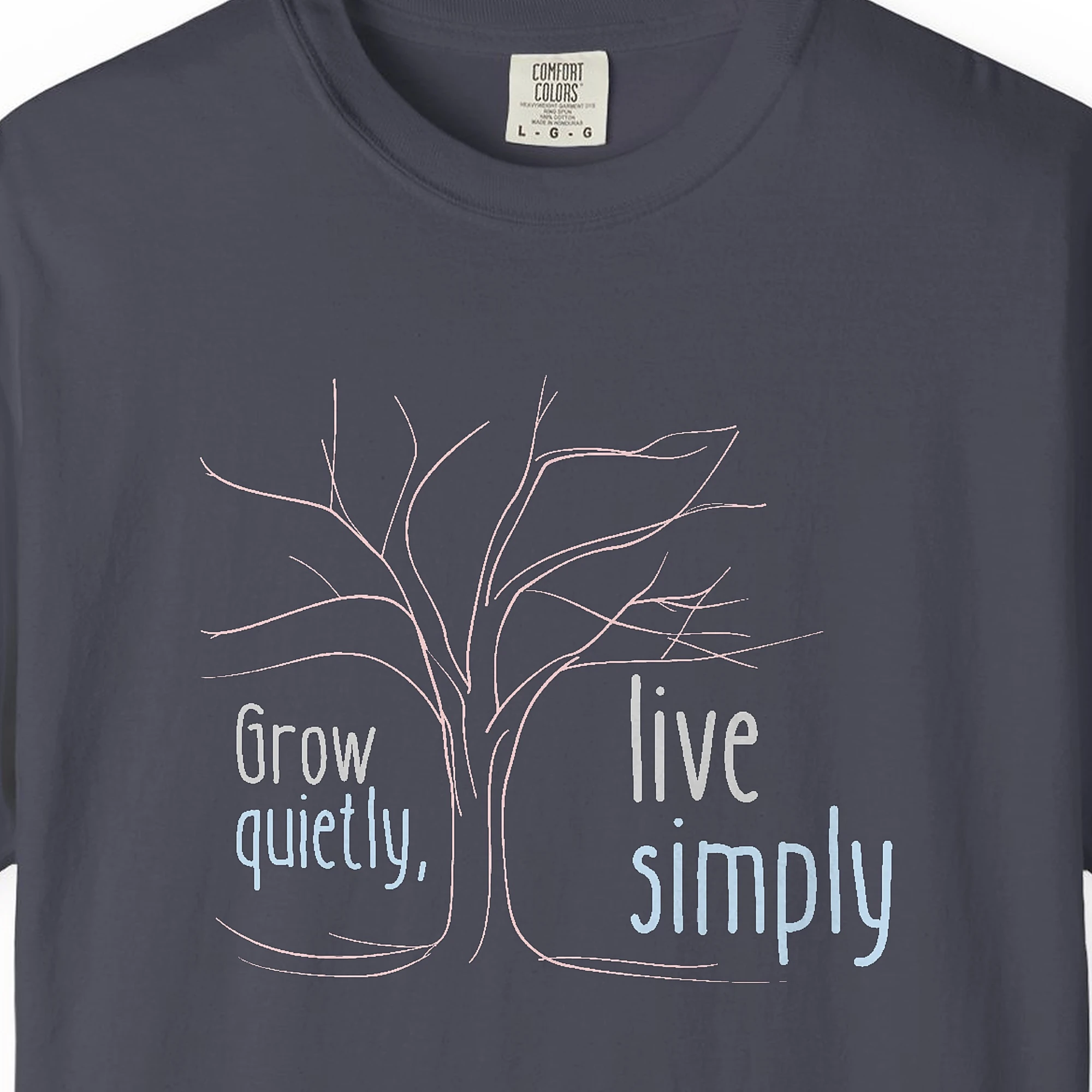Close-up of the Grow Quietly Live Simply print on a Navy Comfort Colors 1717 tee