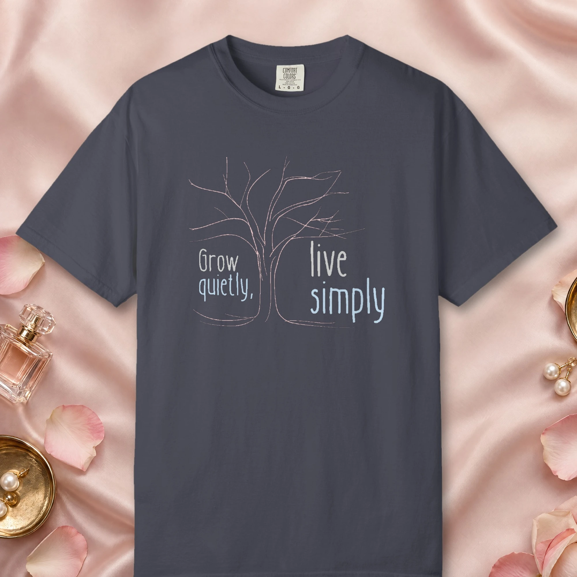 Grow Quietly Live Simply design on a Navy Comfort Colors 1717 tee, laid flat