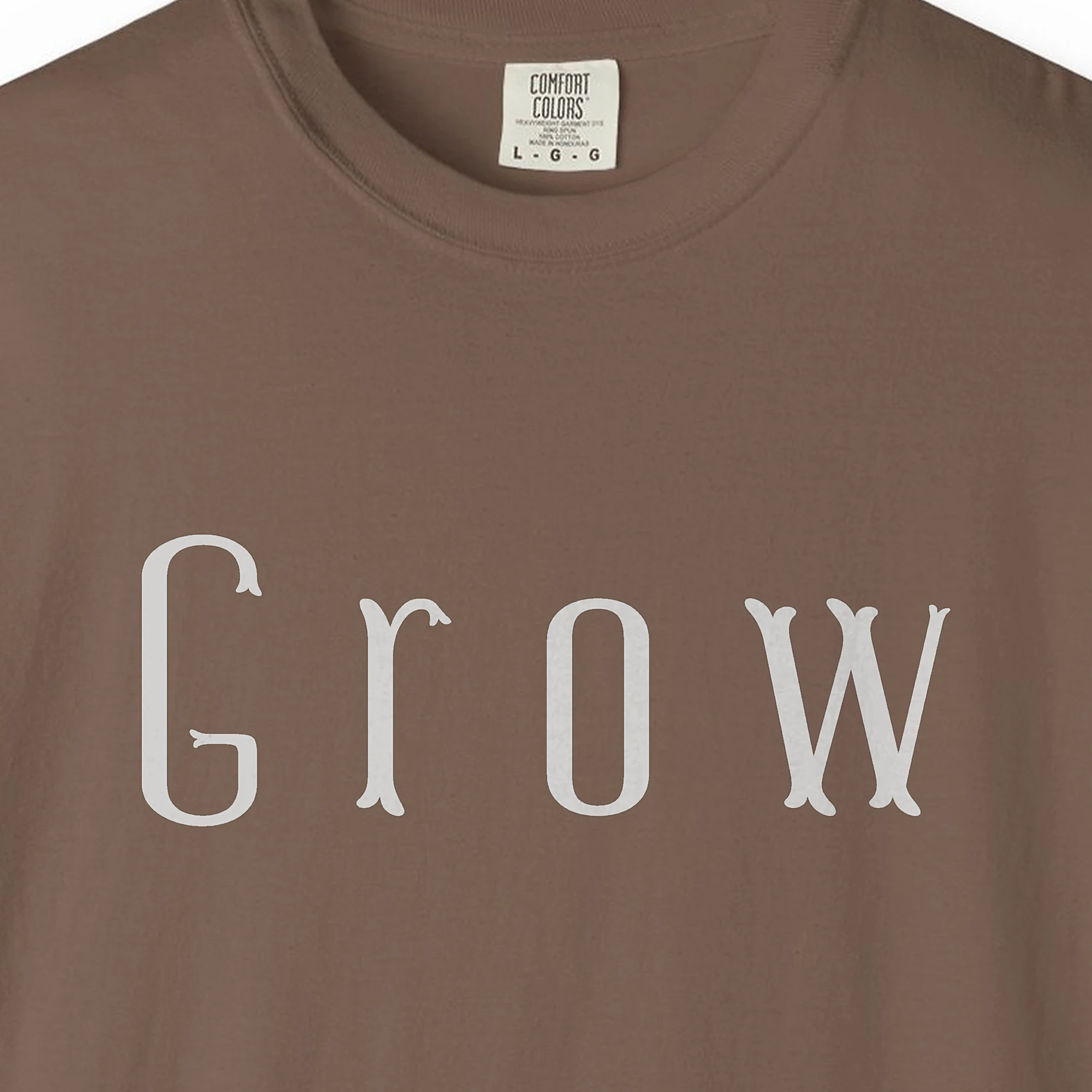 grow-tall-letter-tee-espresso-chest Close-up of the Grow Tall Letter print on a Espresso Comfort Colors 1717 tee