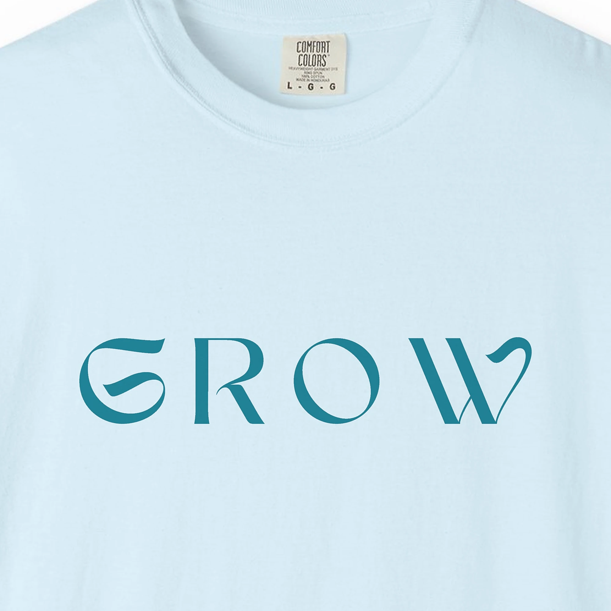 Close-up of the Grow print on a Chambray Comfort Colors 1717 tee
