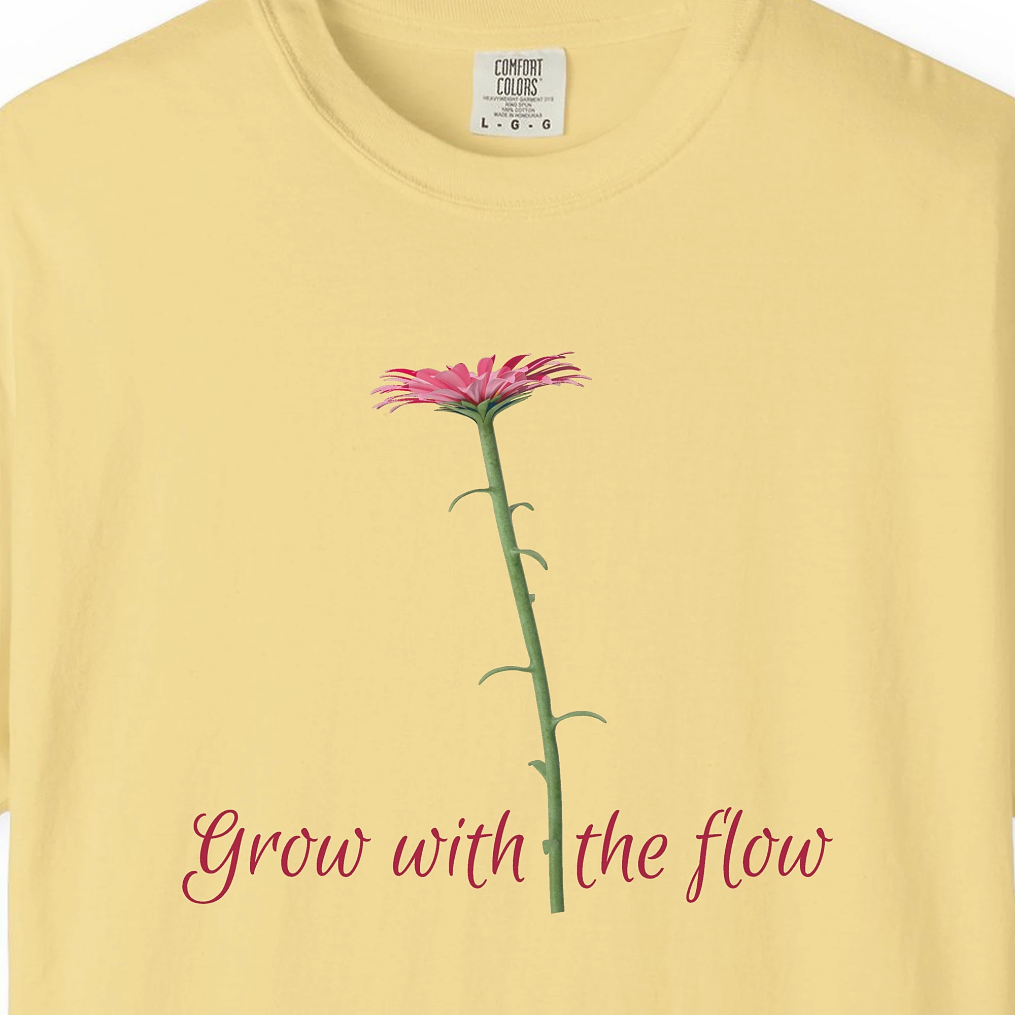 Close-up of the Grow with the Flow print on a Butter Comfort Colors 1717 tee