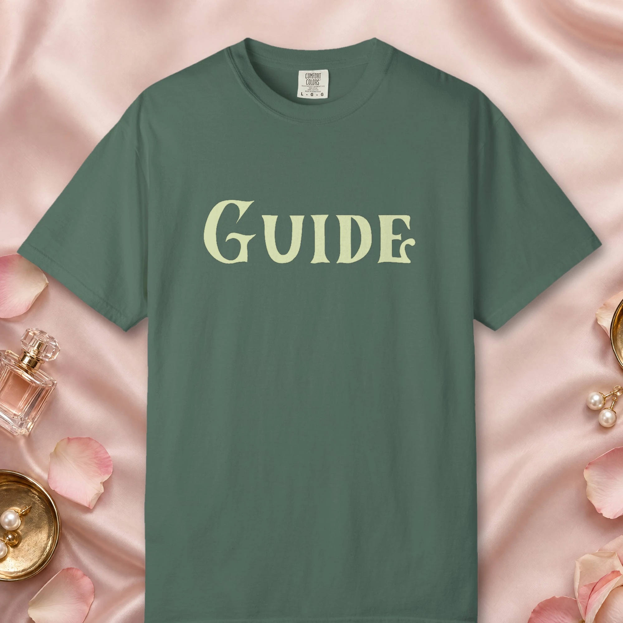 Guide design on a Blue Spruce Comfort Colors 1717 tee, laid flat
