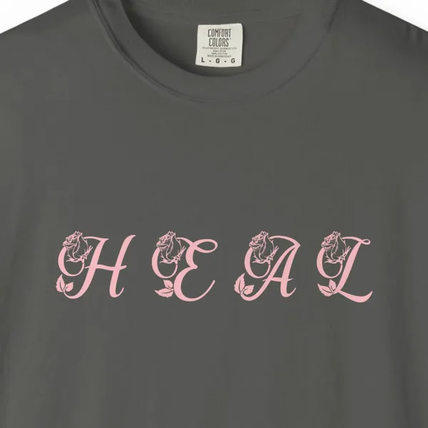 Close-up of the Heal print on a Pepper Comfort Colors 1717 tee