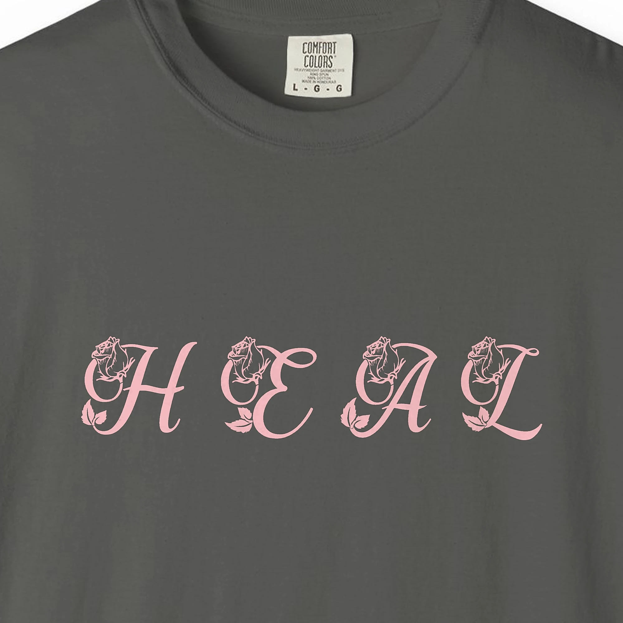 Close-up of the Heal print on a Pepper Comfort Colors 1717 tee