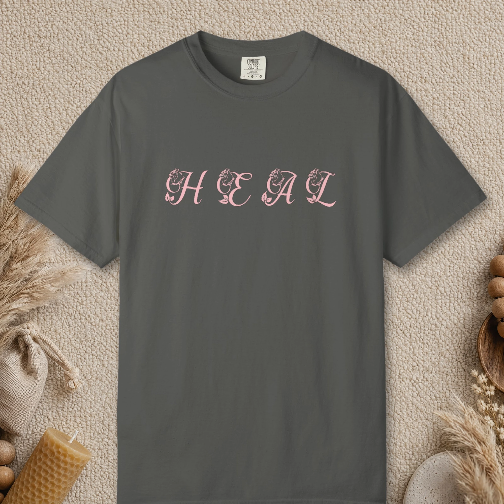 Heal design on a Pepper Comfort Colors 1717 tee, laid flat
