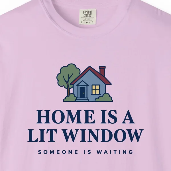 Close-up of the Home Is a Lit Window print on a Orchid Comfort Colors 1717 tee