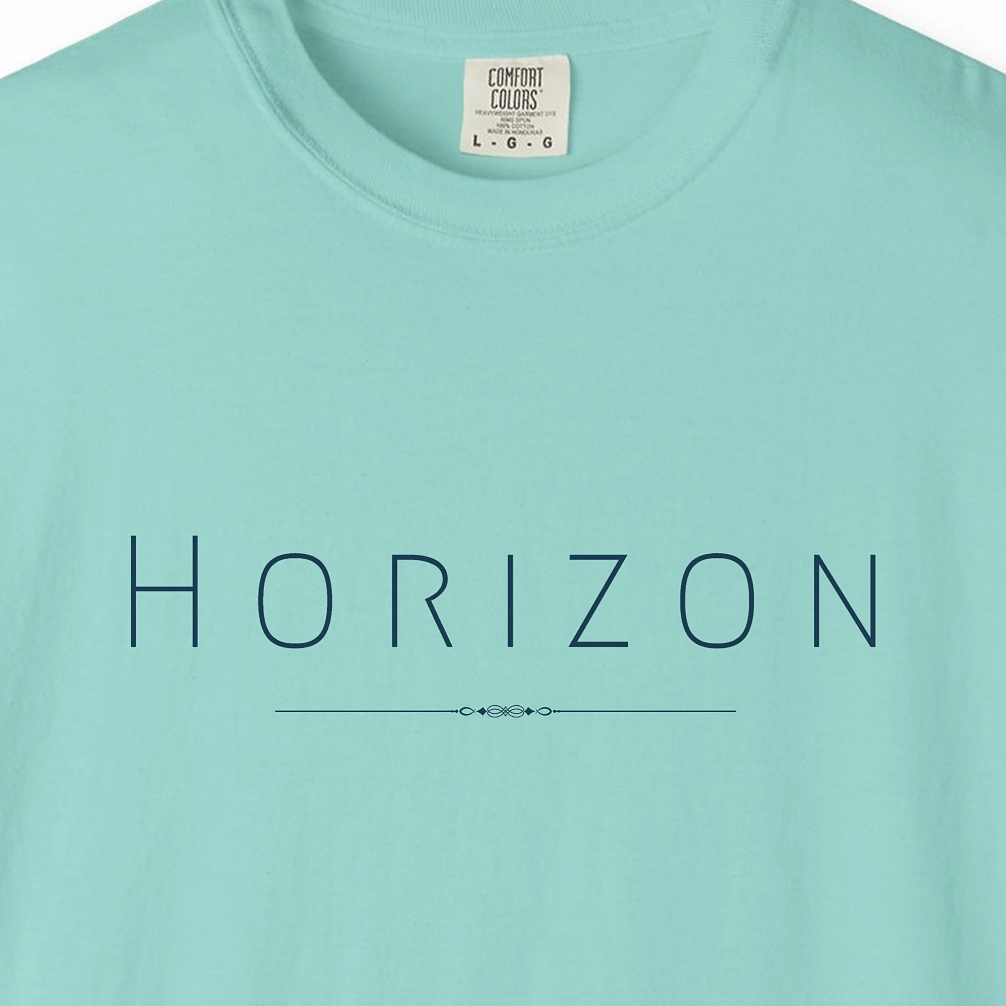 Close-up of the Horizon Line print on a Chalky Mint Comfort Colors 1717 tee