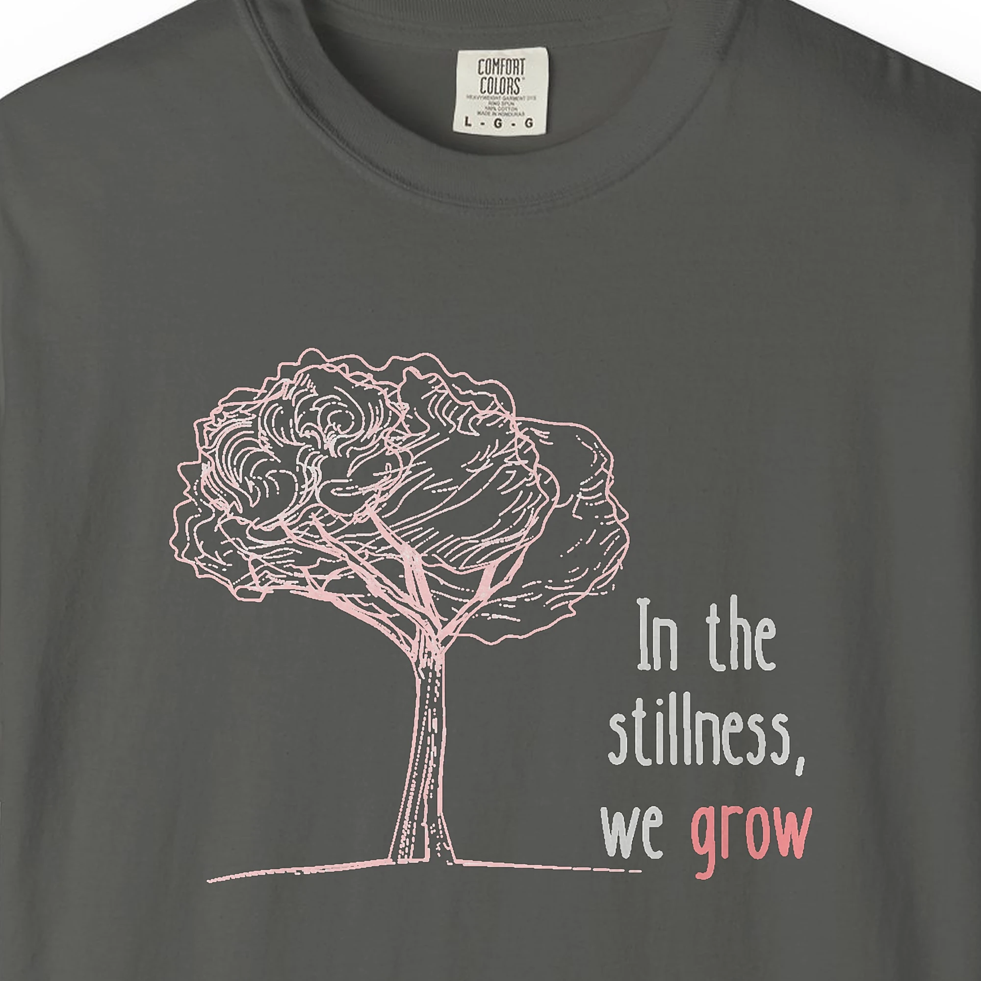 Close-up of the In the Stillness We Grow print on a Pepper Comfort Colors 1717 tee