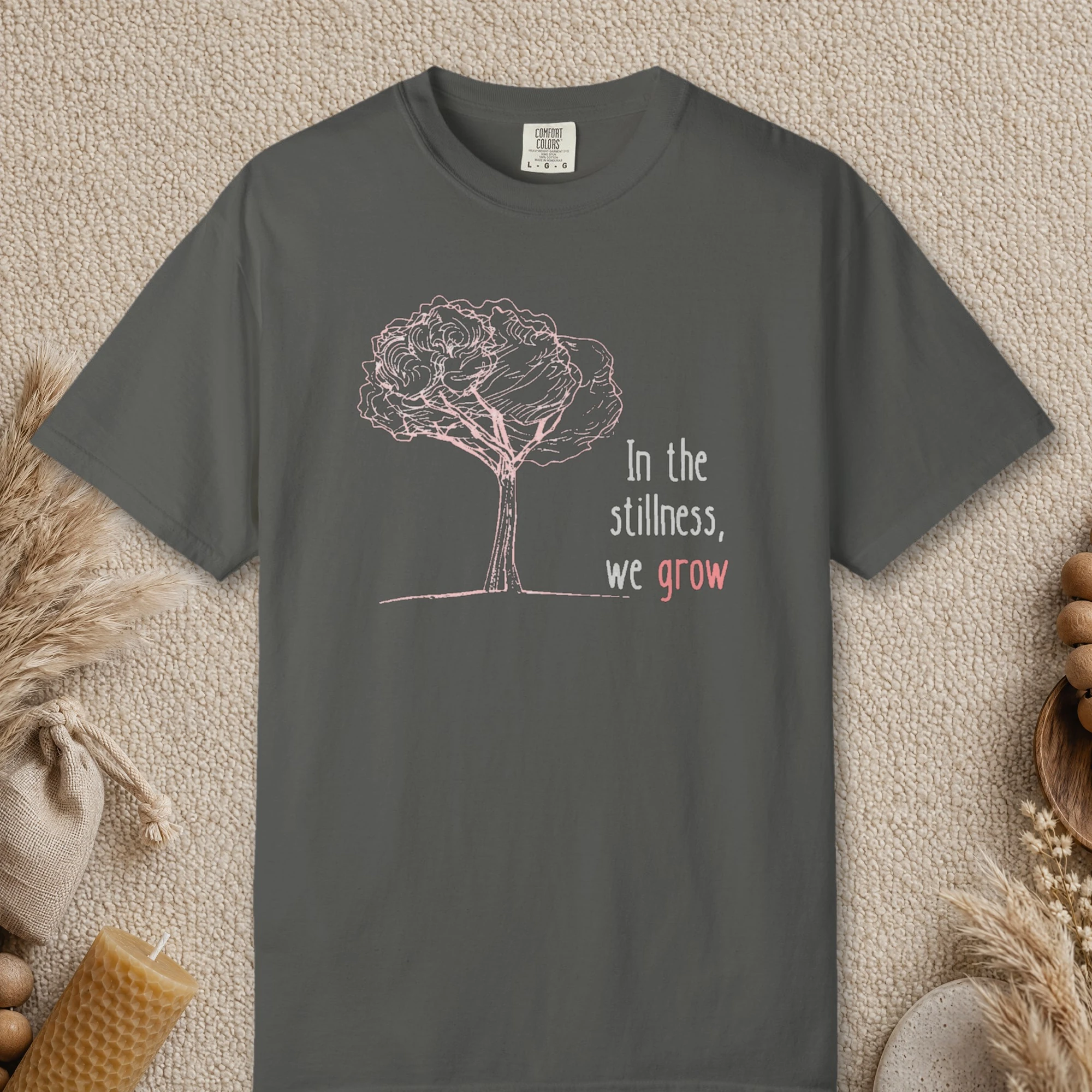 In the Stillness We Grow design on a Pepper Comfort Colors 1717 tee, laid flat