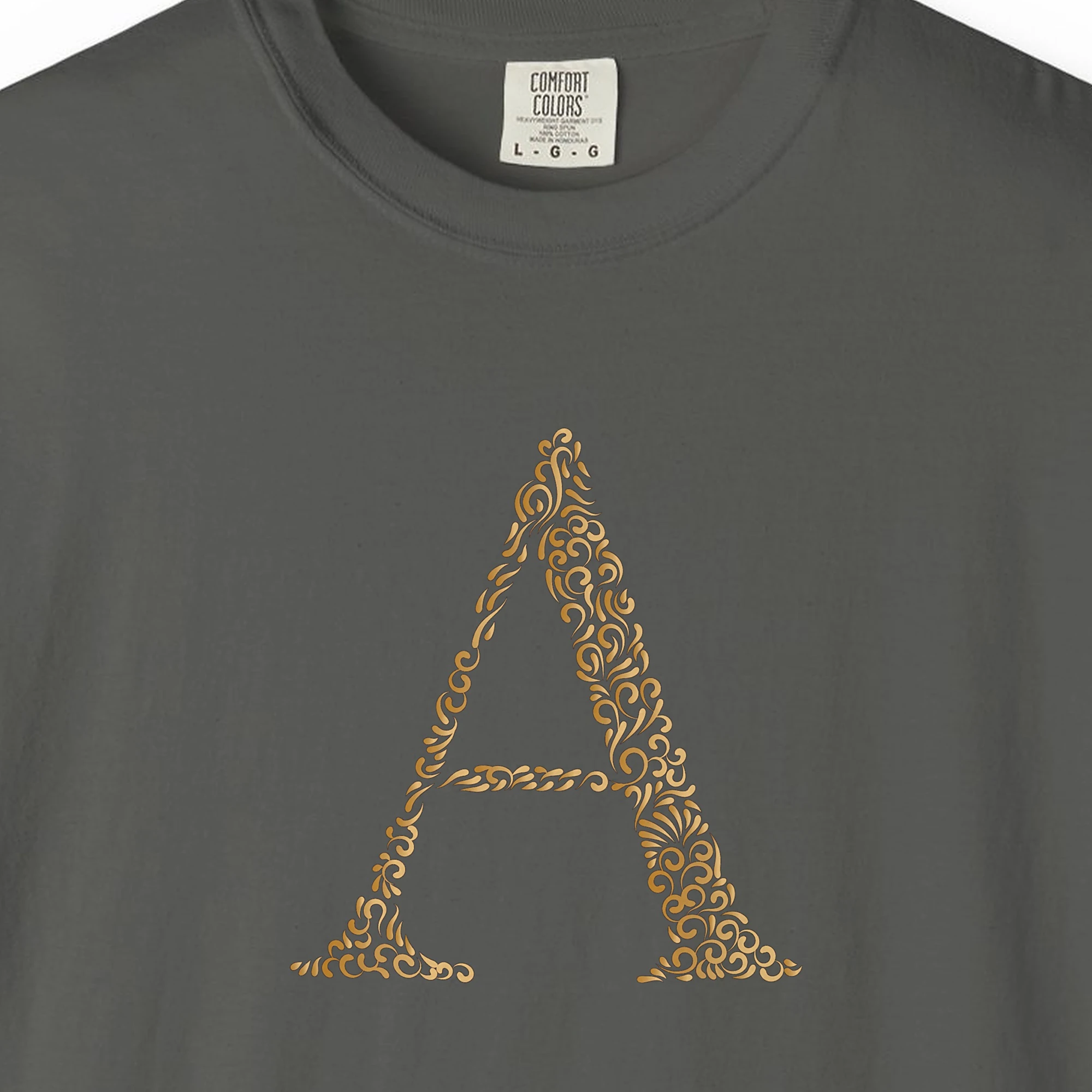 Close-up of the Initial A print on a Pepper Comfort Colors 1717 tee