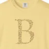 initial-b-tee-butter-chest Close-up of the Initial B print on a Butter Comfort Colors 1717 tee