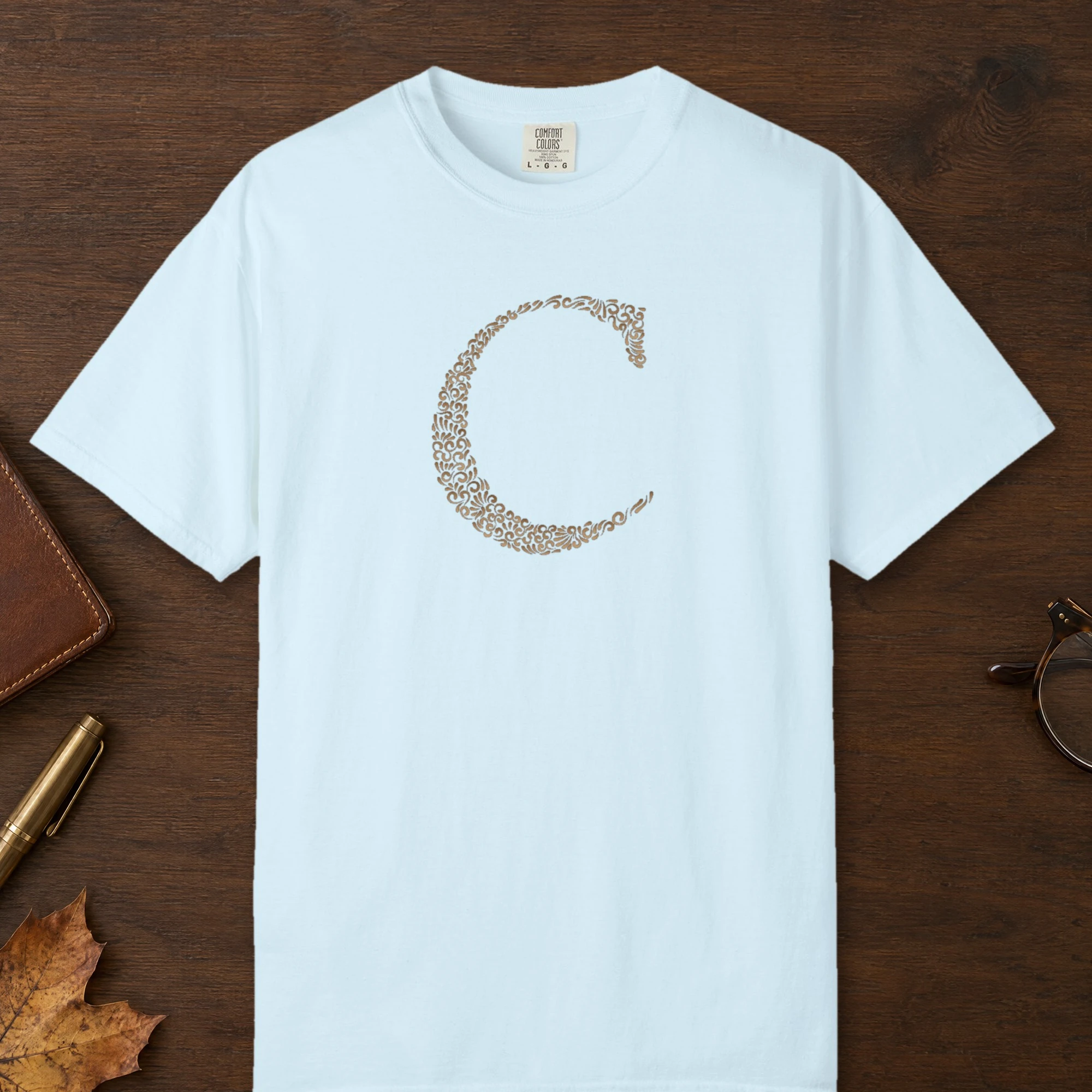 Initial C design on a Chambray Comfort Colors 1717 tee, laid flat