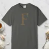 Initial F design on a Pepper Comfort Colors 1717 tee, laid flat
