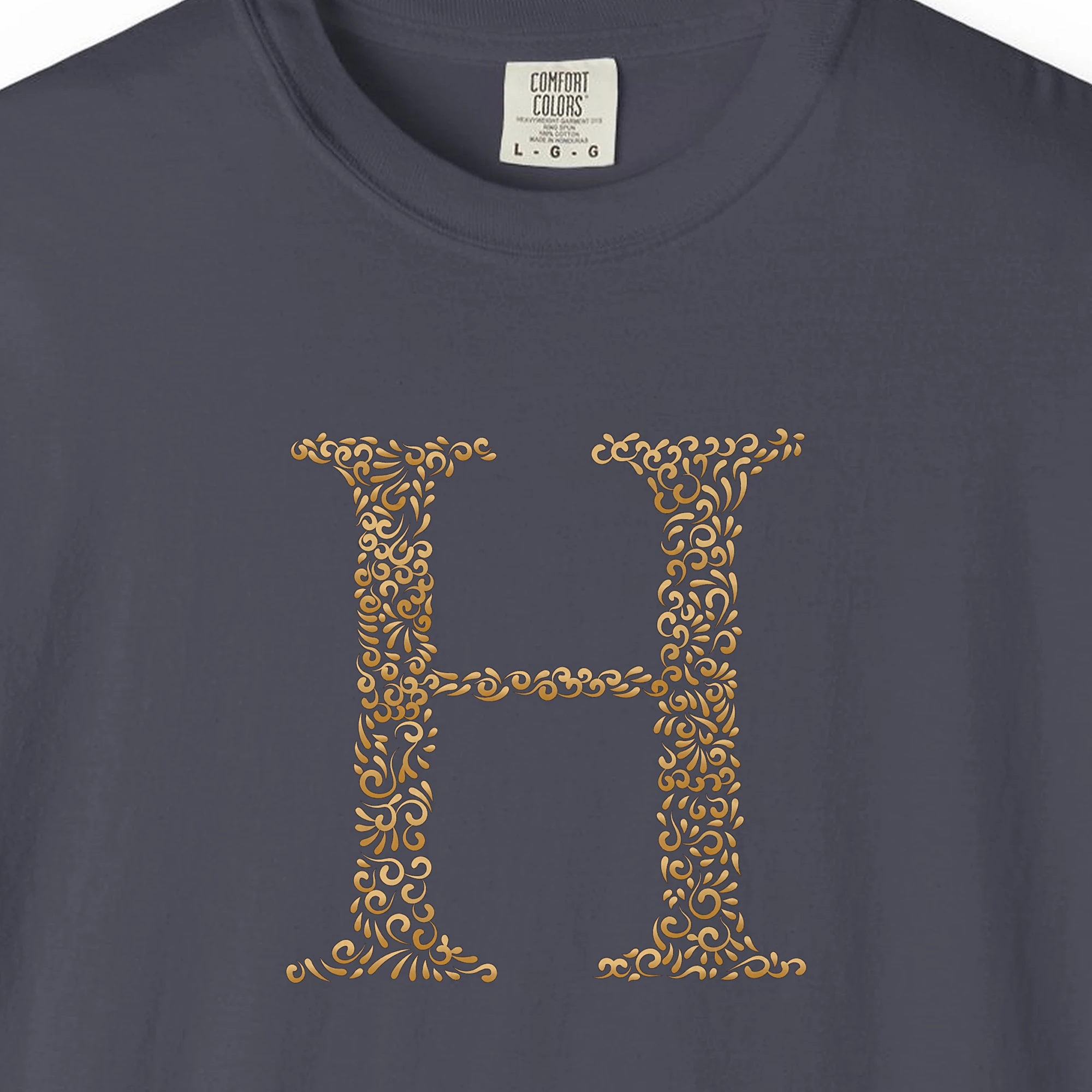 Close-up of the Initial H print on a Navy Comfort Colors 1717 tee