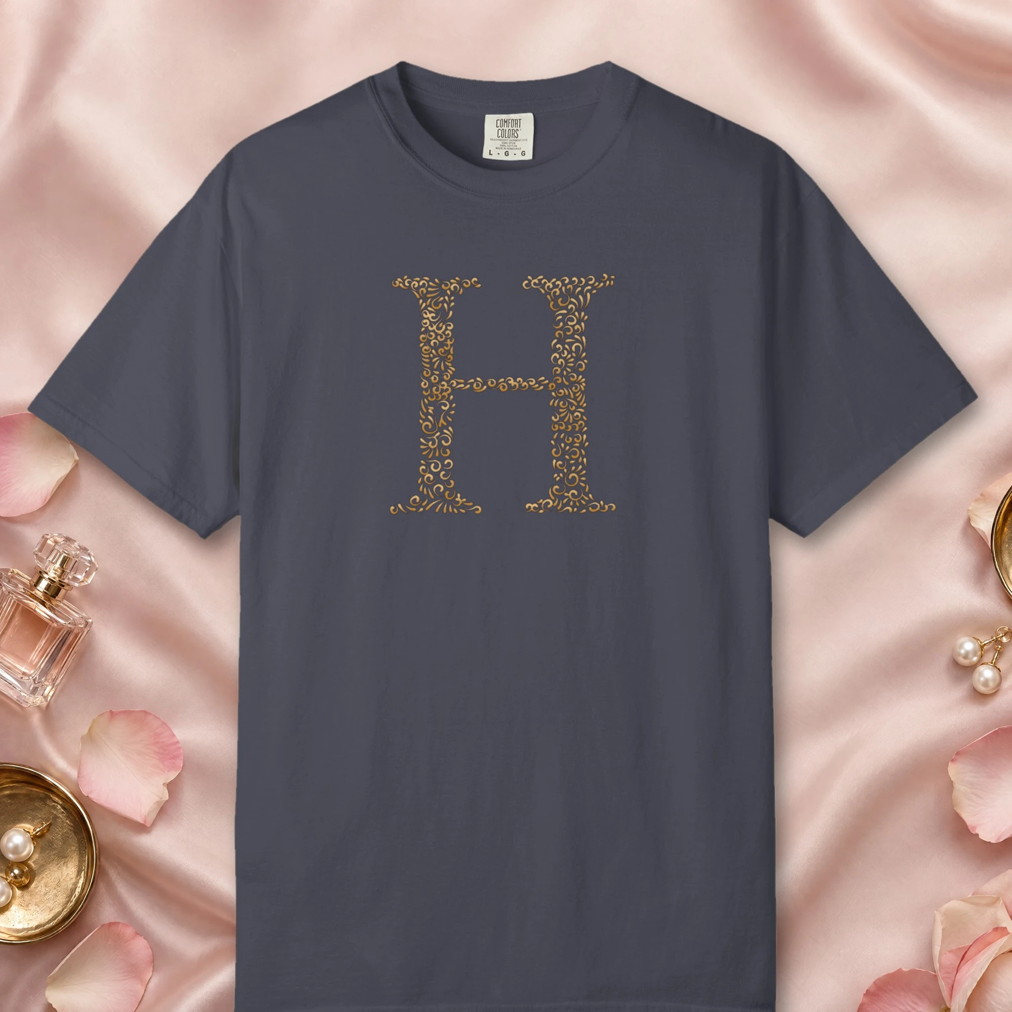 Initial H design on a Navy Comfort Colors 1717 tee, laid flat
