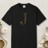 Initial J design on a Black Comfort Colors 1717 tee, laid flat