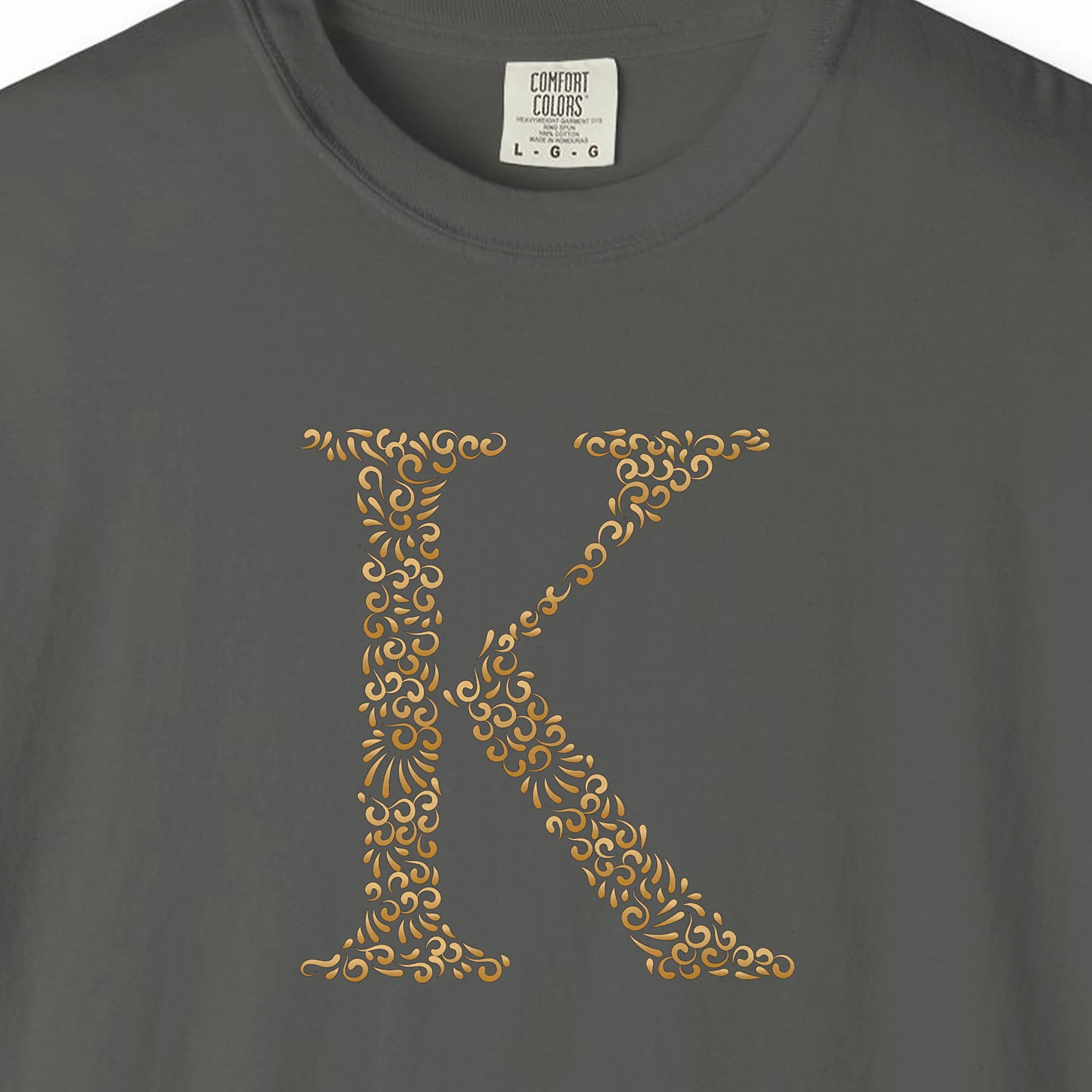 Close-up of the Initial K print on a Pepper Comfort Colors 1717 tee
