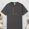 Initial L design on a Graphite Comfort Colors 1717 tee, laid flat
