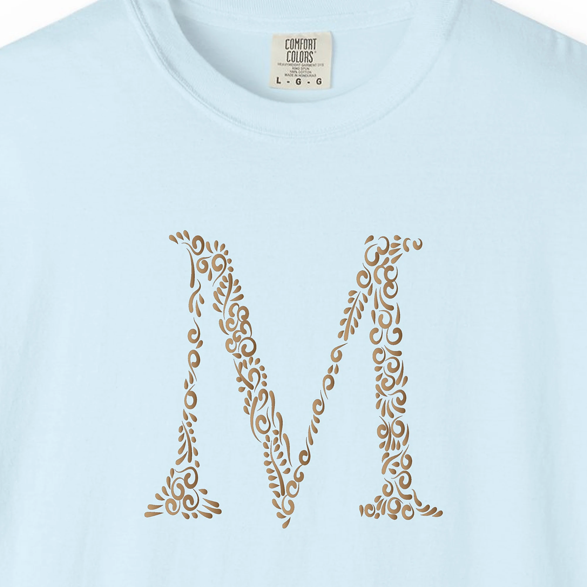 Close-up of the Initial M print on a Chambray Comfort Colors 1717 tee