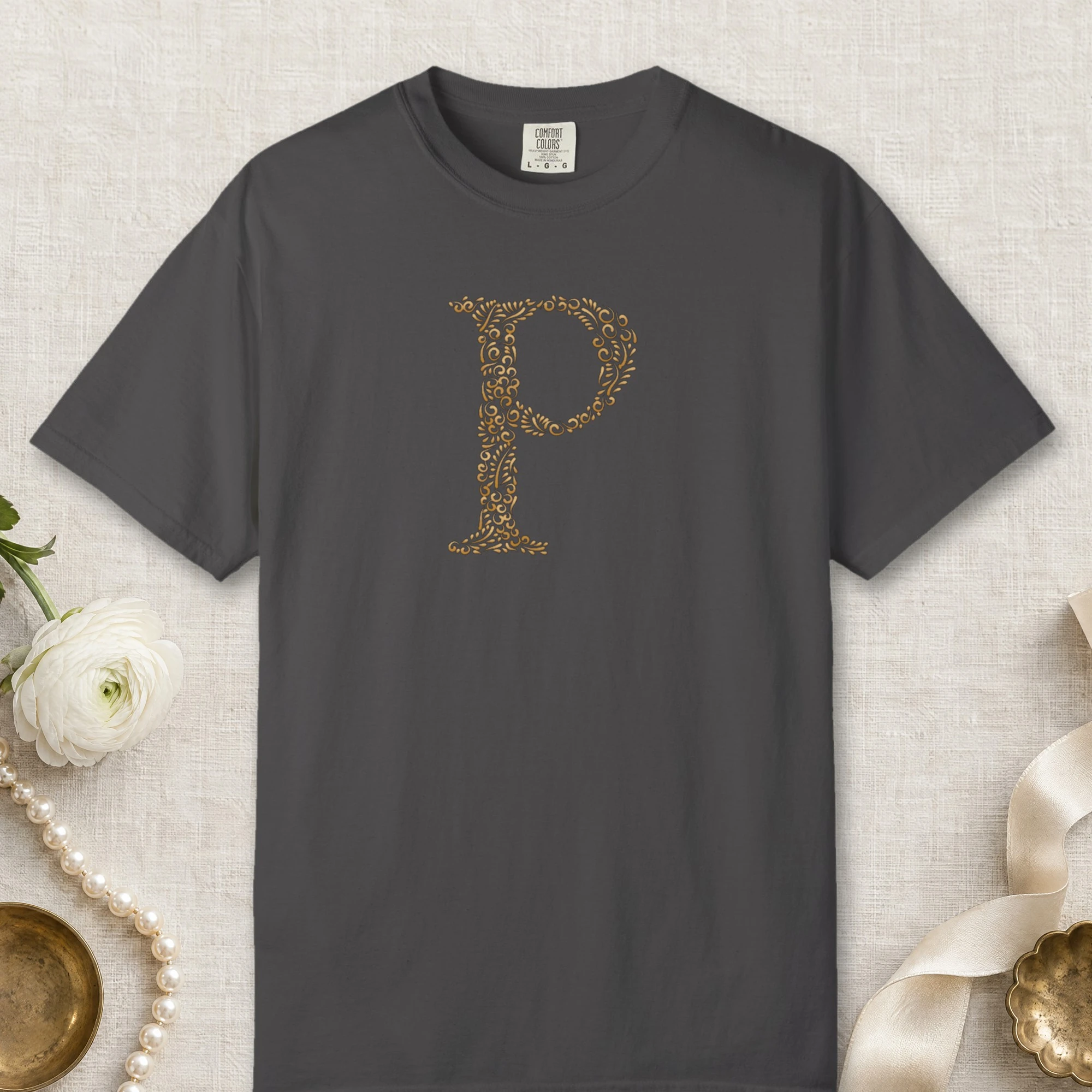 Initial P design on a Graphite Comfort Colors 1717 tee, laid flat