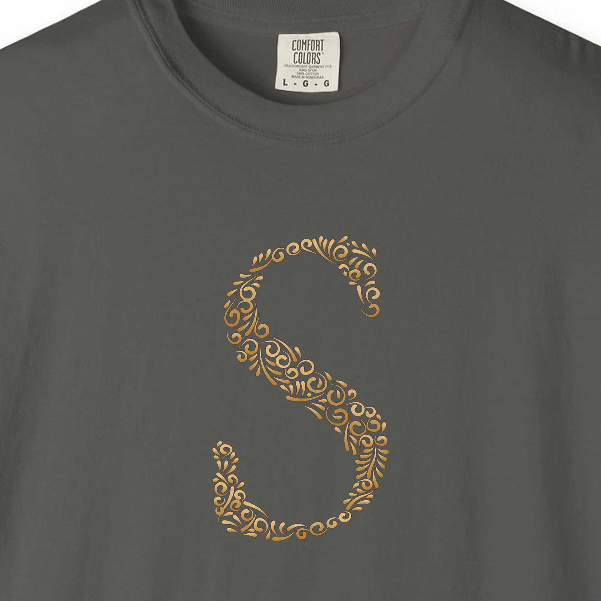 Close-up of the Initial S print on a Pepper Comfort Colors 1717 tee