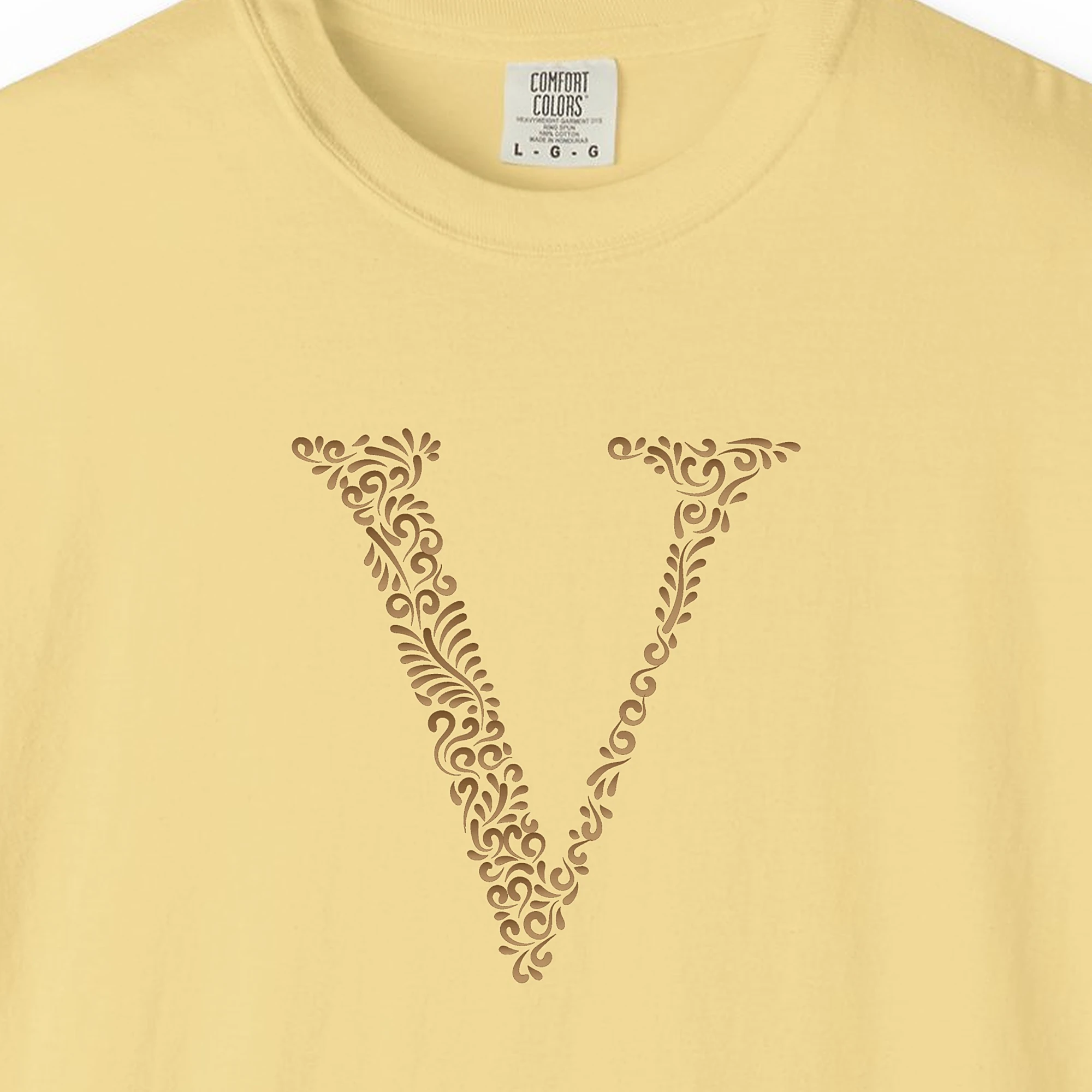 Close-up of the Initial V print on a Butter Comfort Colors 1717 tee