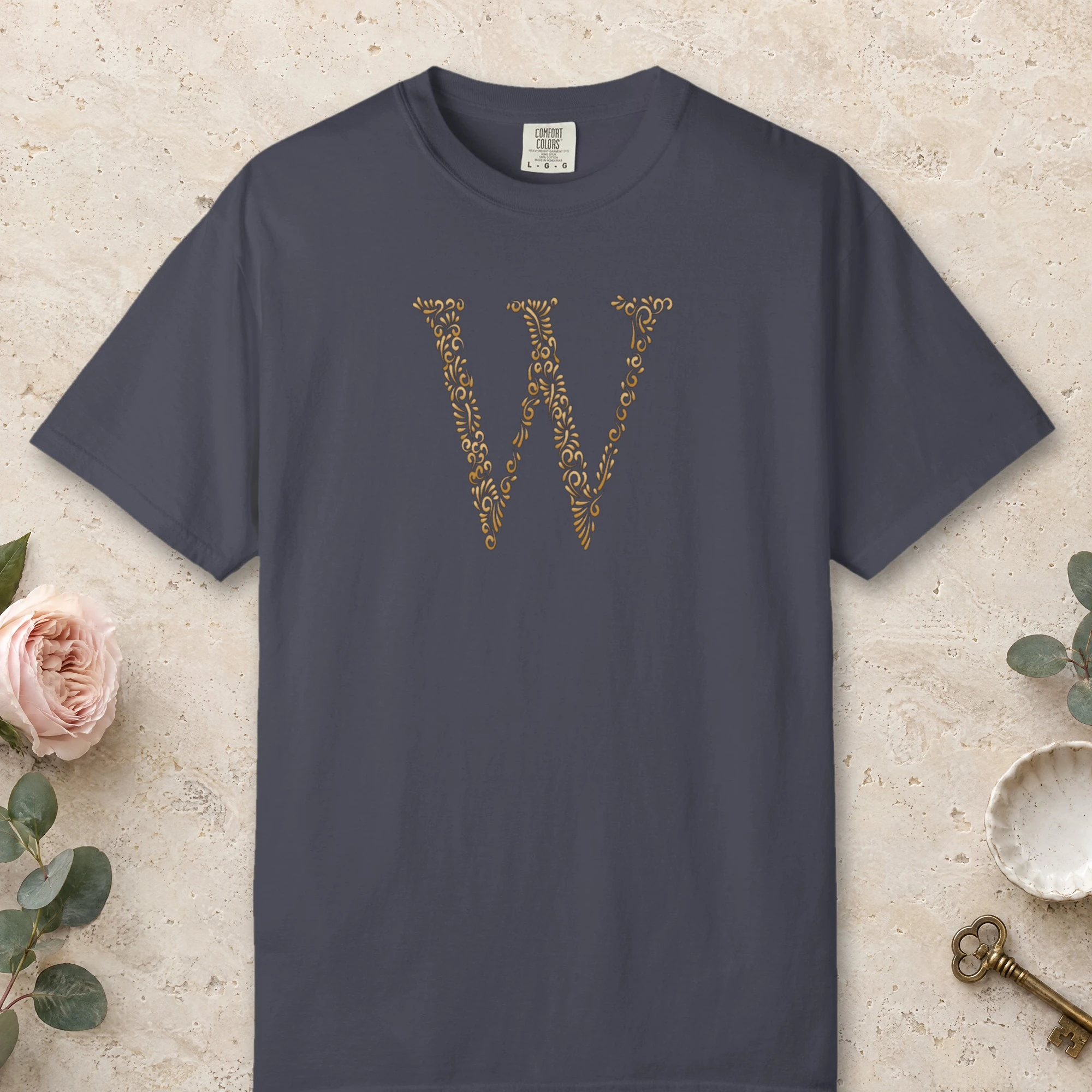 Initial W design on a Navy Comfort Colors 1717 tee, laid flat