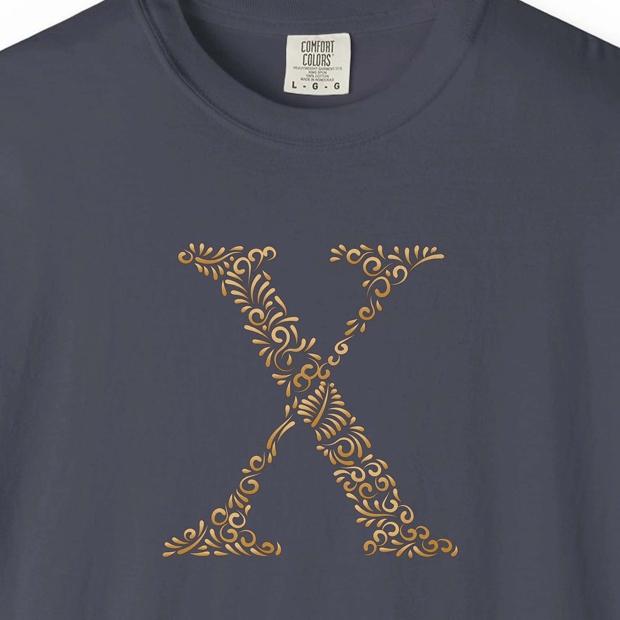 Close-up of the Initial X print on a Navy Comfort Colors 1717 tee