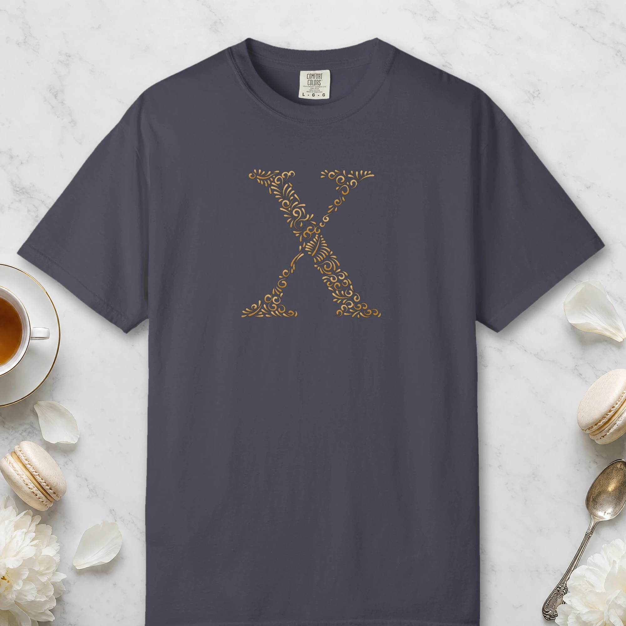 Initial X design on a Navy Comfort Colors 1717 tee, laid flat