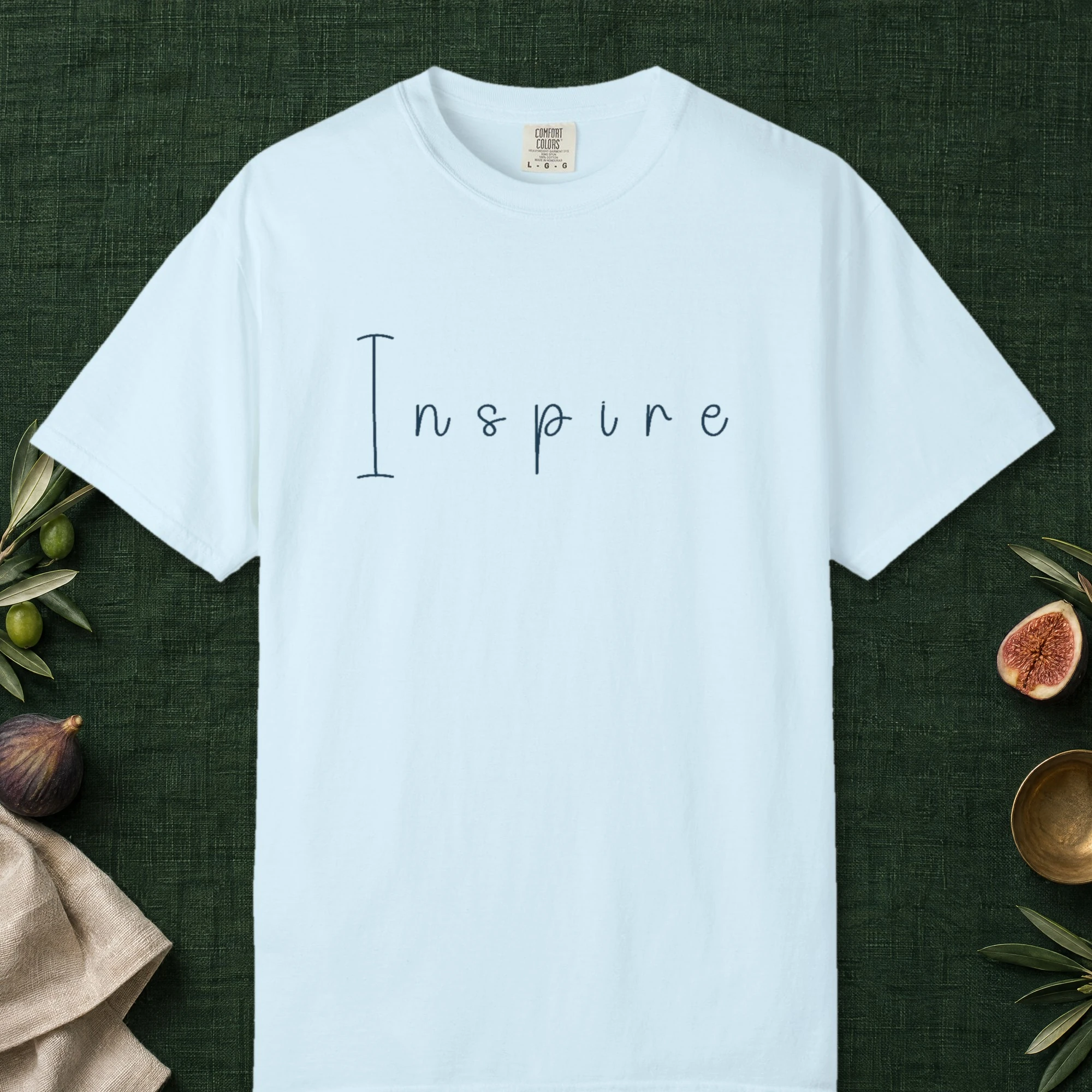Inspire Hand-Drawn design on a Chambray Comfort Colors 1717 tee, laid flat