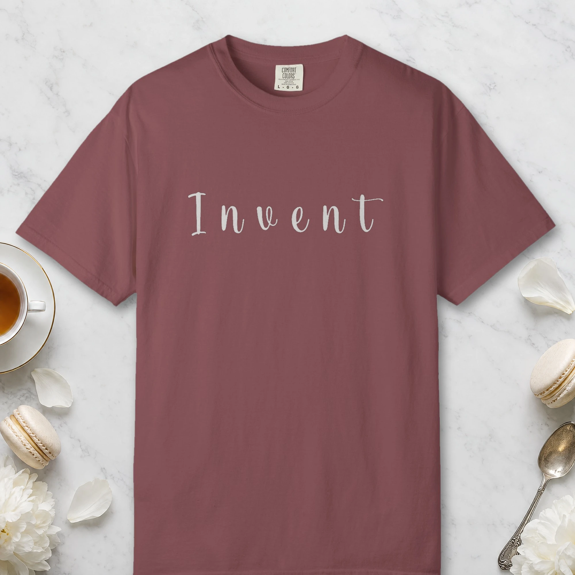 Invent Slab Serif design on a Brick Comfort Colors 1717 tee, laid flat