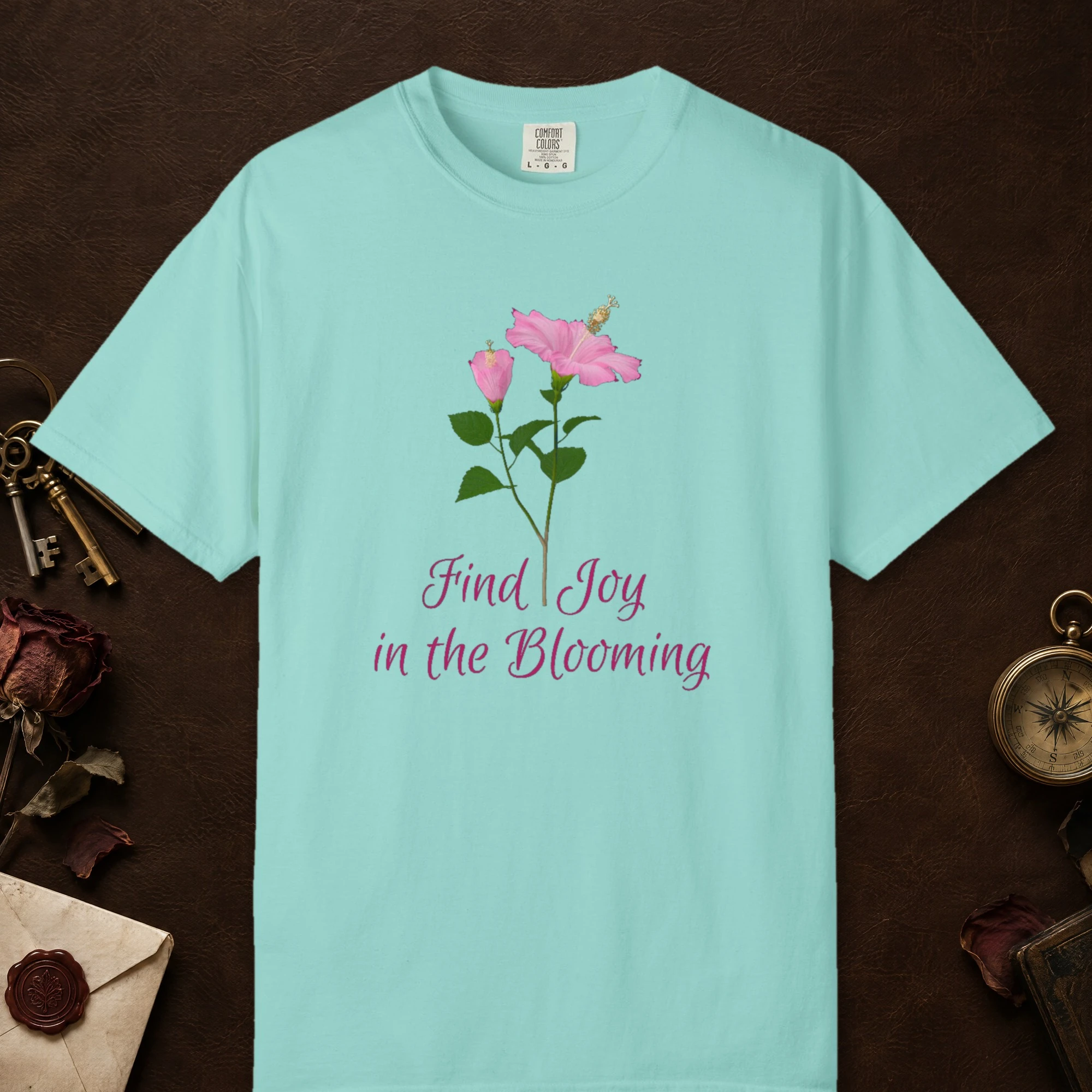 Joy in the Blooming design on a Chalky Mint Comfort Colors 1717 tee, laid flat