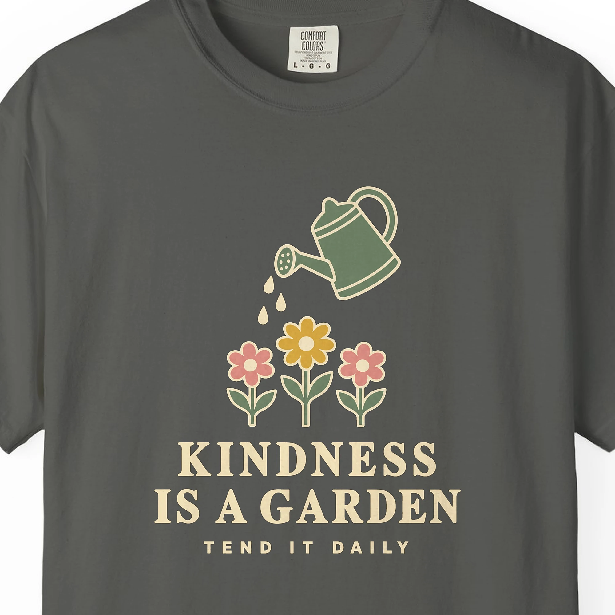 kindness-is-a-garden-tee-pepper-chest Close-up of the Kindness Is a Garden print on a Pepper Comfort Colors 1717 tee