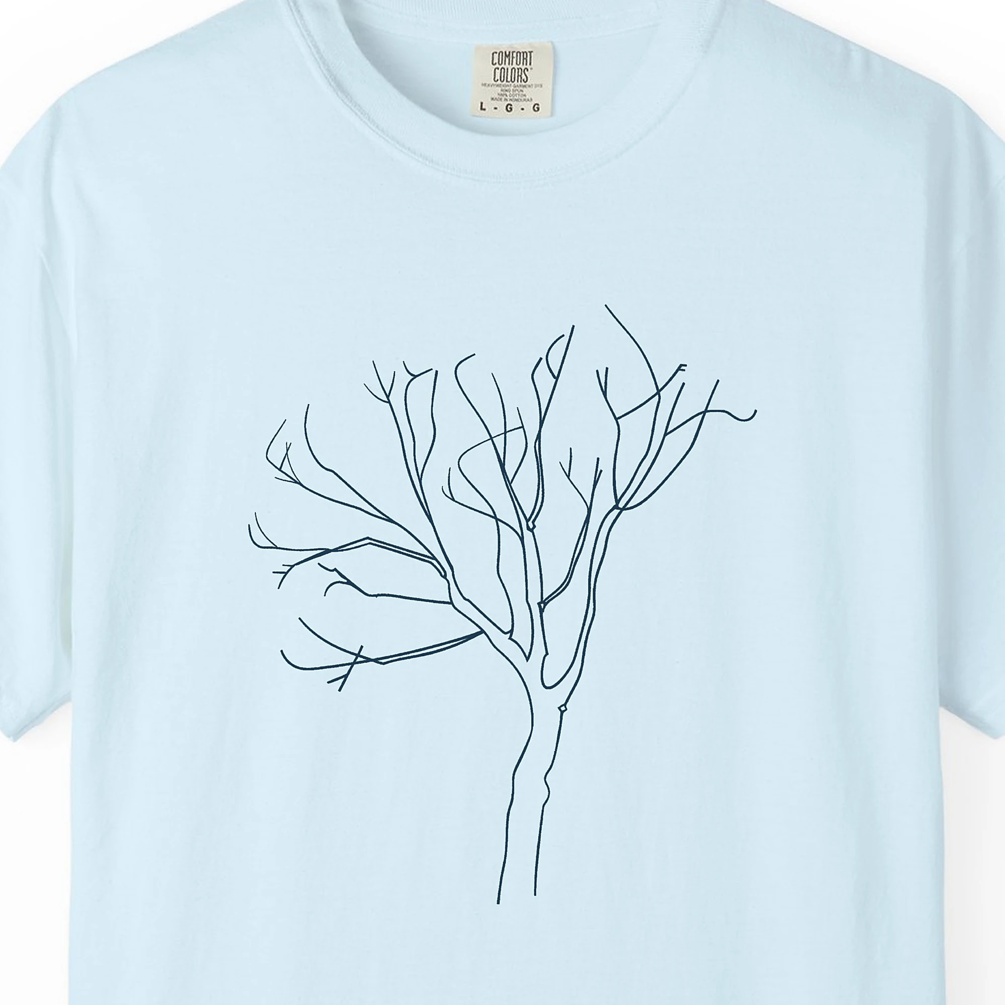 Close-up of the Leaning Bare Tree print on a Chambray Comfort Colors 1717 tee