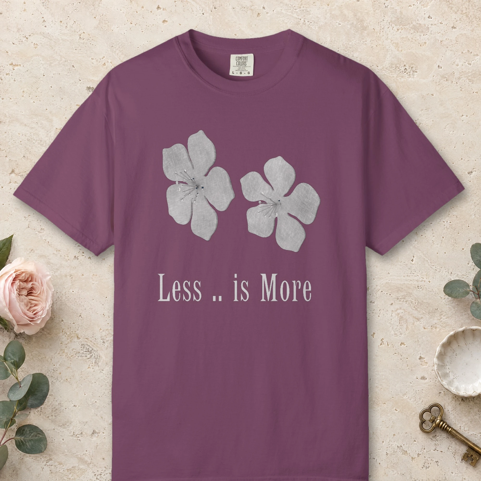Less Is More Flowers design on a Berry Comfort Colors 1717 tee, laid flat