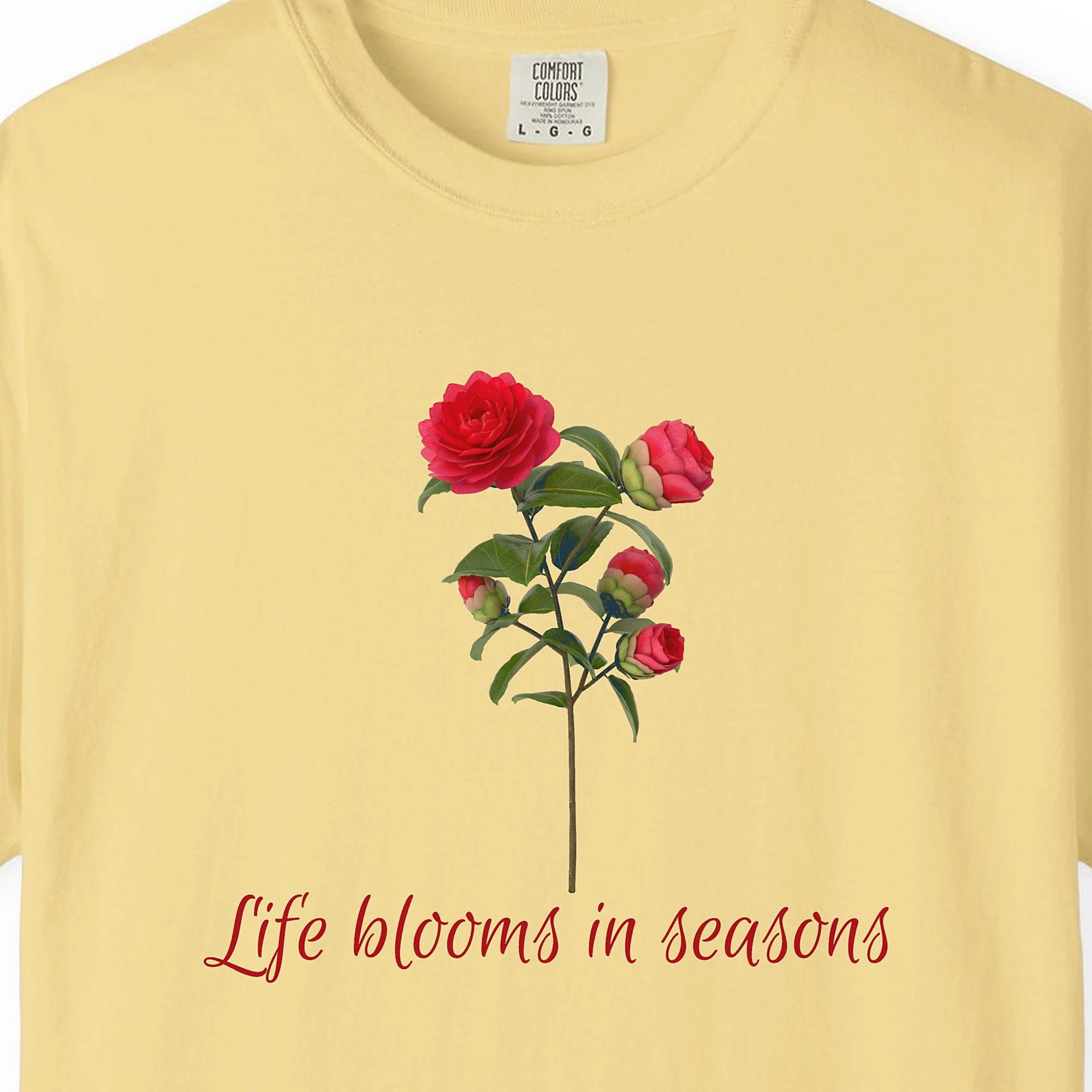 Close-up of the Life Blooms in Seasons print on a Butter Comfort Colors 1717 tee
