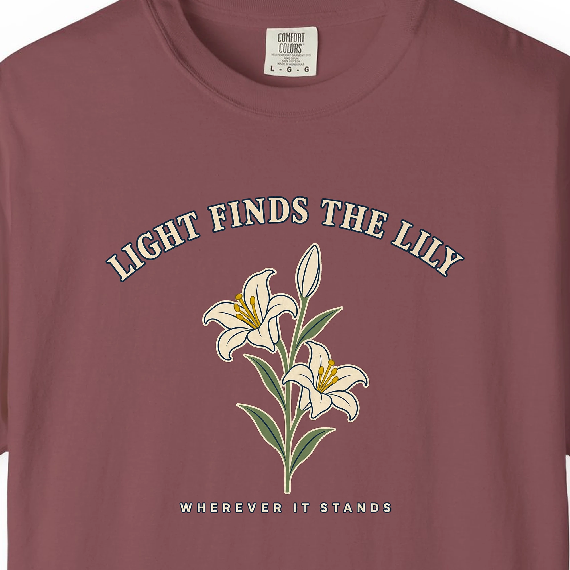 light-finds-the-lily-tee-brick-chest Close-up of the Light Finds the Lily print on a Brick Comfort Colors 1717 tee