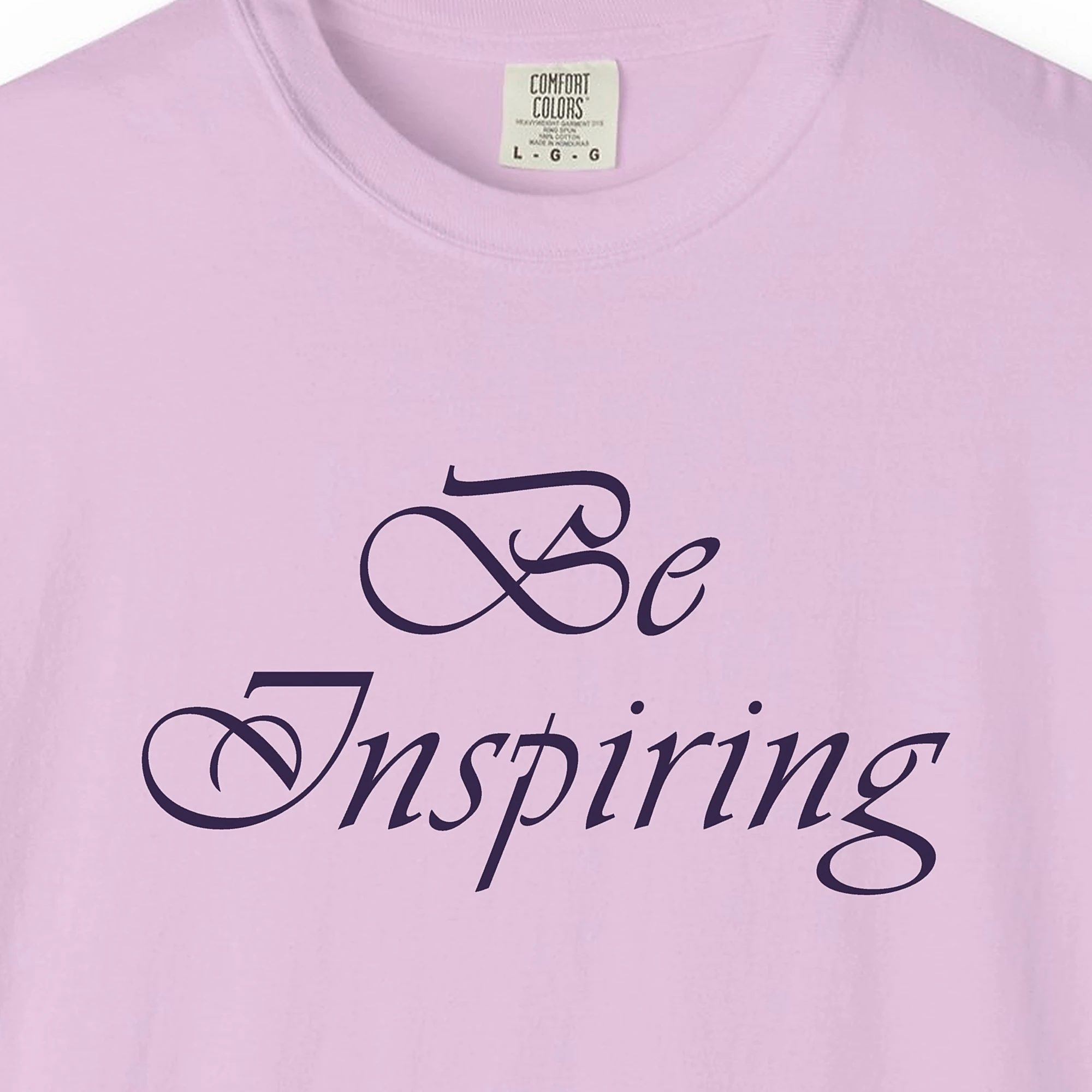 Close-up of the Light for Others print on a Orchid Comfort Colors 1717 tee