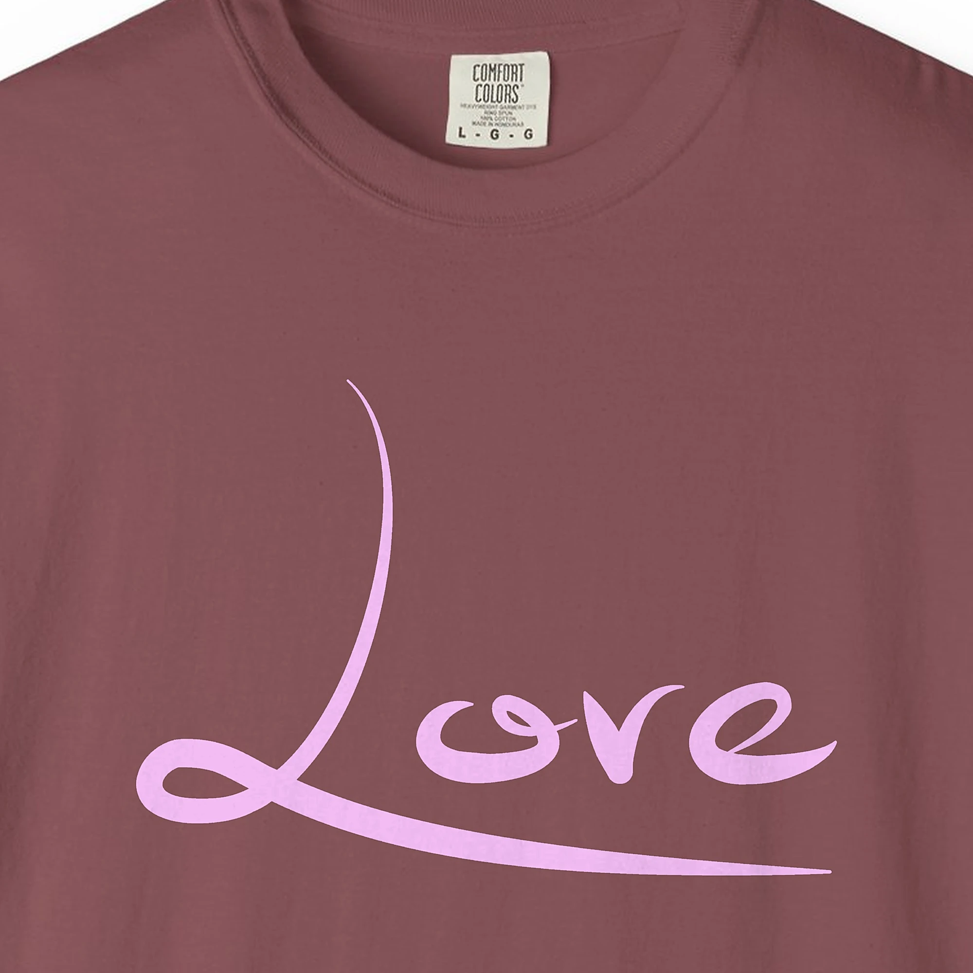 Close-up of the Love print on a Brick Comfort Colors 1717 tee