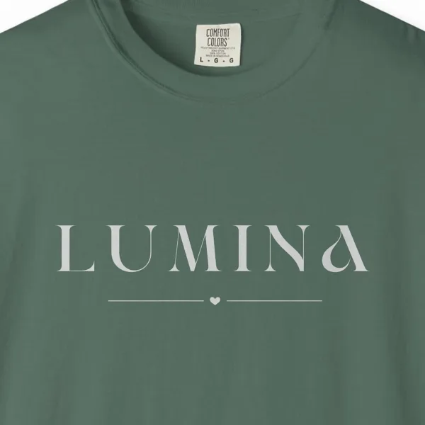lumina-little-heart-tee-blue-spruce-chest Close-up of the Lumina Little Heart print on a Blue Spruce Comfort Colors 1717 tee