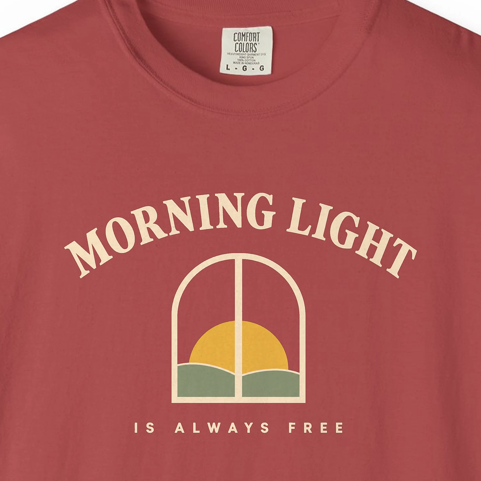 morning-light-is-always-free-tee-crimson-chest Close-up of the Morning Light Is Always Free print on a Crimson Comfort Colors 1717 tee