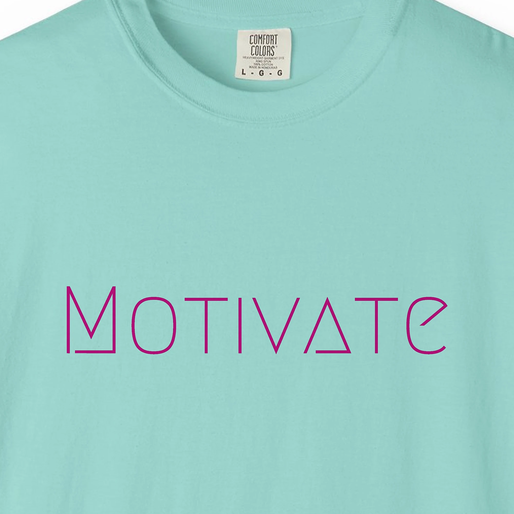Close-up of the Motivate print on a Chalky Mint Comfort Colors 1717 tee